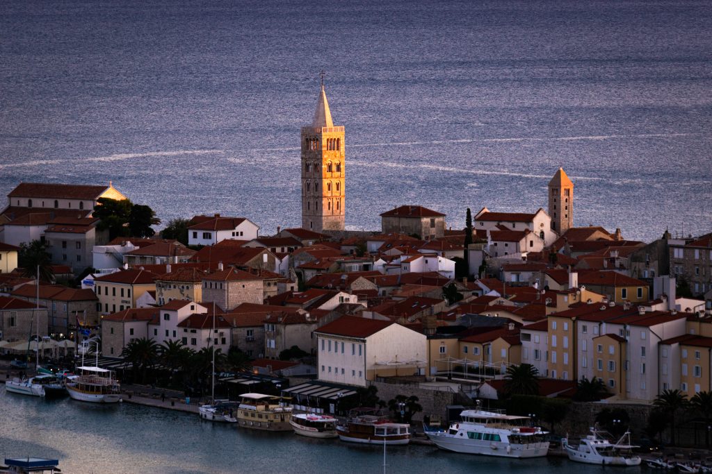 Rab is a Croatian island in the Adriatic Sea. It’s known for the old town of the same name, encircled by ancient walls. The town’s 4 prominent church bell towers include the Romanesque tower at the Cathedral Svete Marije (St. Mary) and the tower at the ruins of Sveti Ivan Church (St. John the Evangelist).